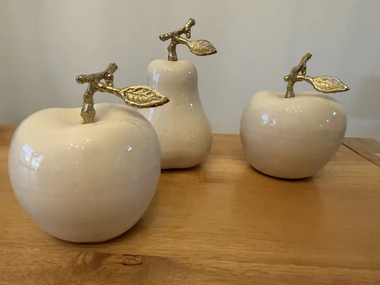 Ceramic apples and a pear, with gilded leaves
